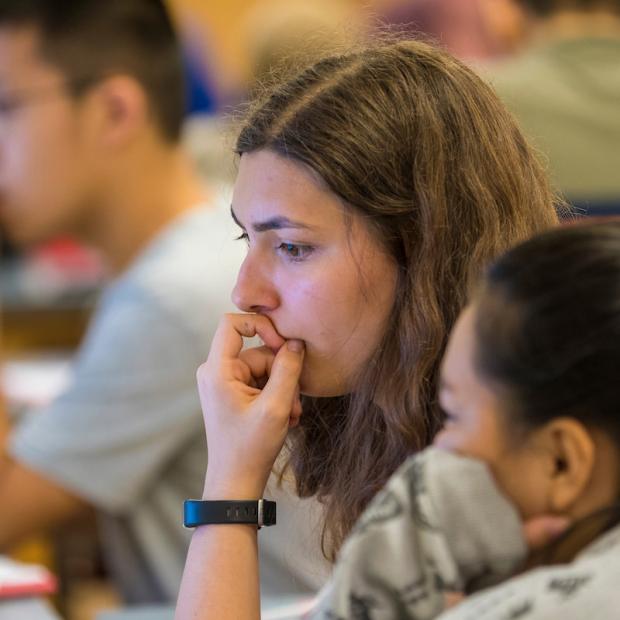 Students concentrate to solve a puzzle