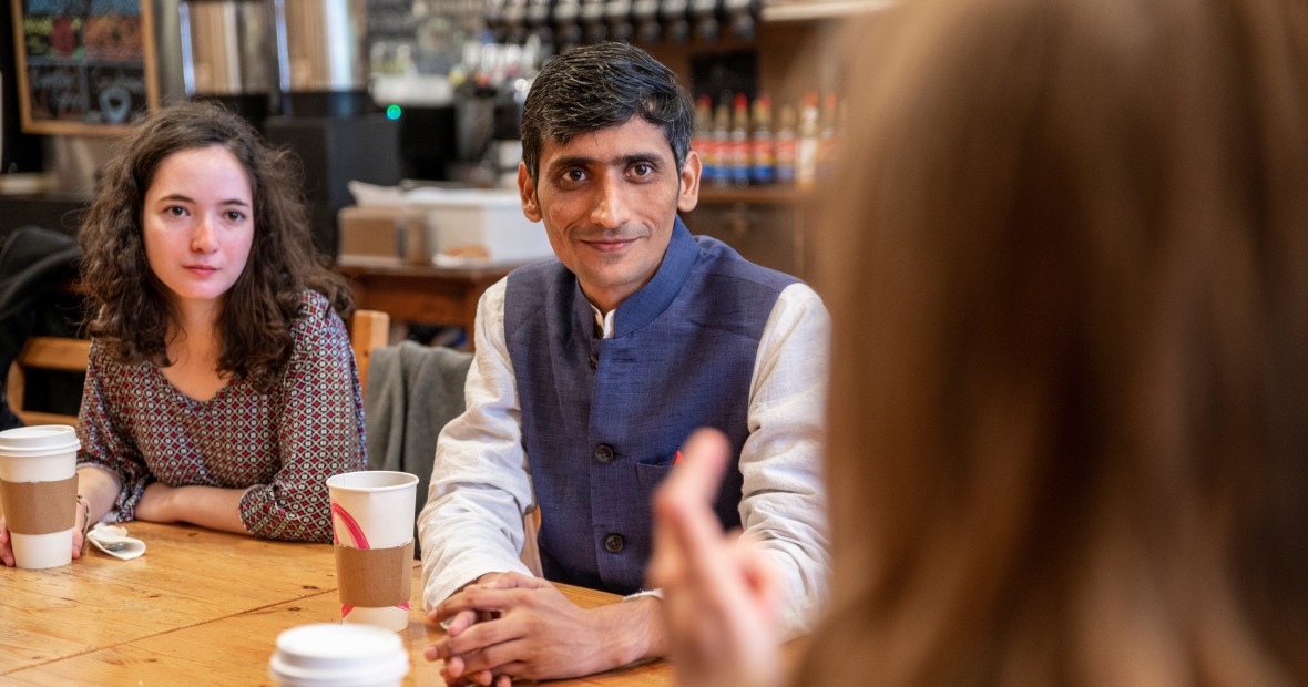 man at coffee shop with students