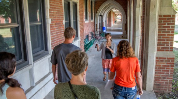 A student leading a tour of prospective students.