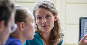 Charlotte Christensen looks over MAP work with Hollis Akins and  Anna Engelhardt